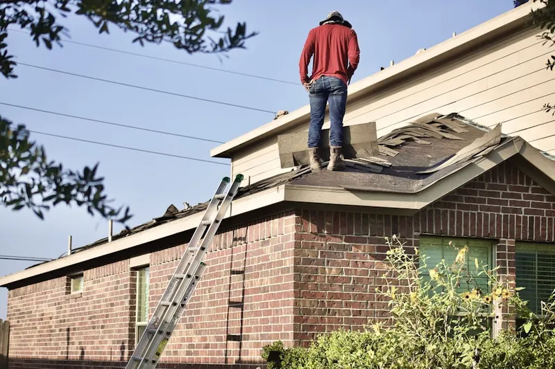 Professional roofer working on a residential roof in Two Rivers